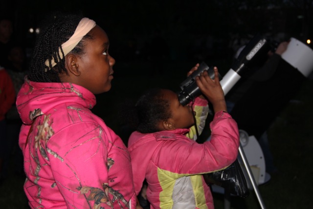 Mother and daughter at a telescope